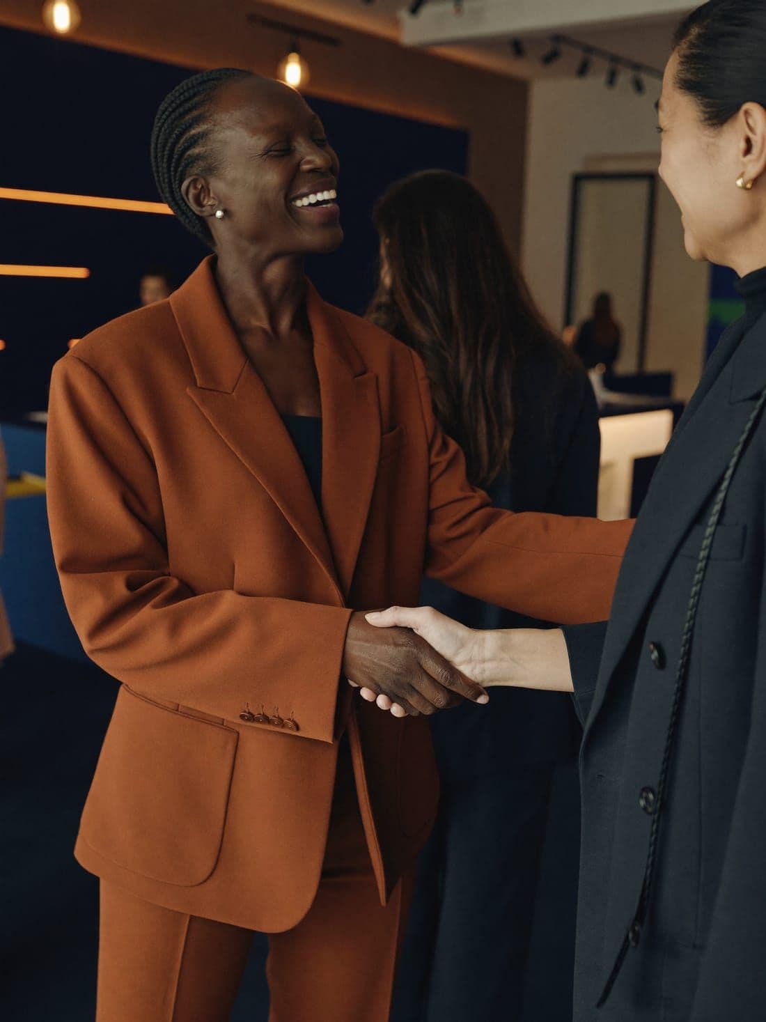 Two professional women meeting at a networking event
